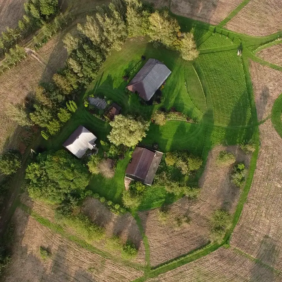 The homestead from above: the farmhouse, garden, mown paths and meadows